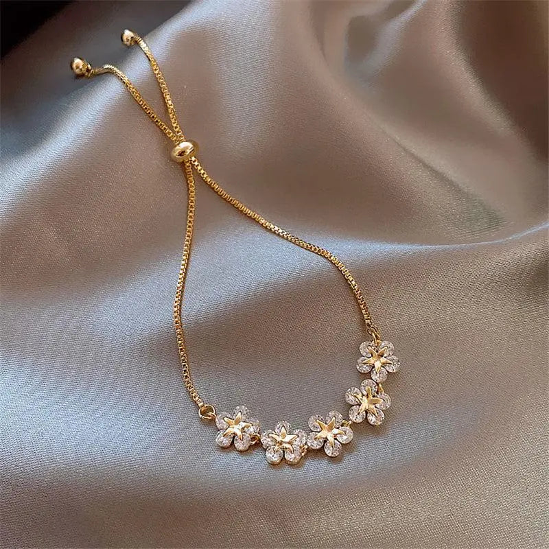 Braccialetto dorato con margherite e cristalli